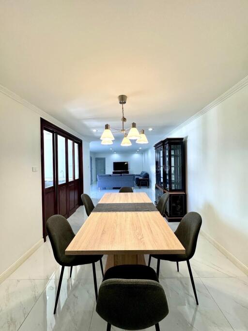 Modern dining room with wooden table and black chairs