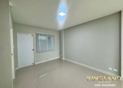 Main living space with glossy tiled flooring and window with blinds