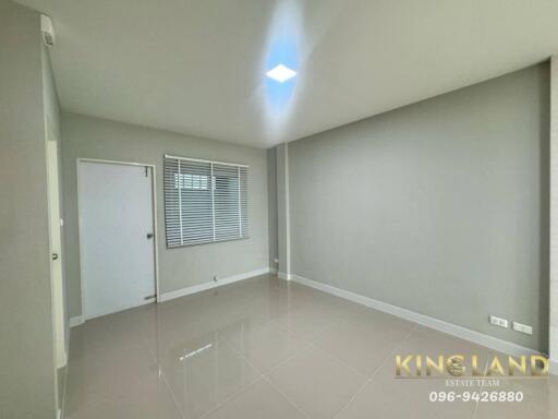 Main living space with glossy tiled flooring and window with blinds