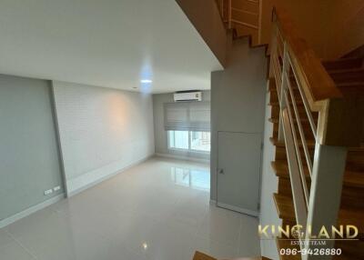 bright and empty living room with staircase