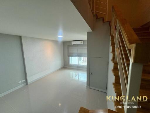 bright and empty living room with staircase