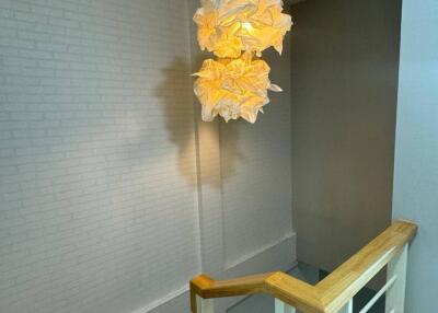 Staircase with modern light fixture