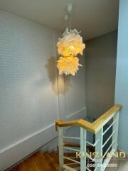 Staircase with modern light fixture