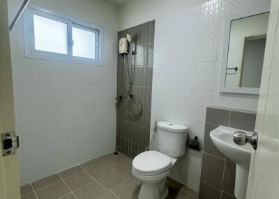 Modern bathroom with shower, toilet, and sink