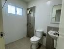 Modern bathroom with shower, toilet, and sink