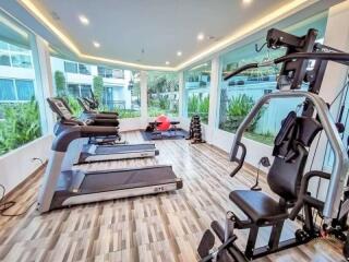 Modern fitness center with exercise machines and weights