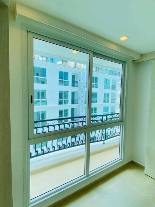 Room with large window and balcony view