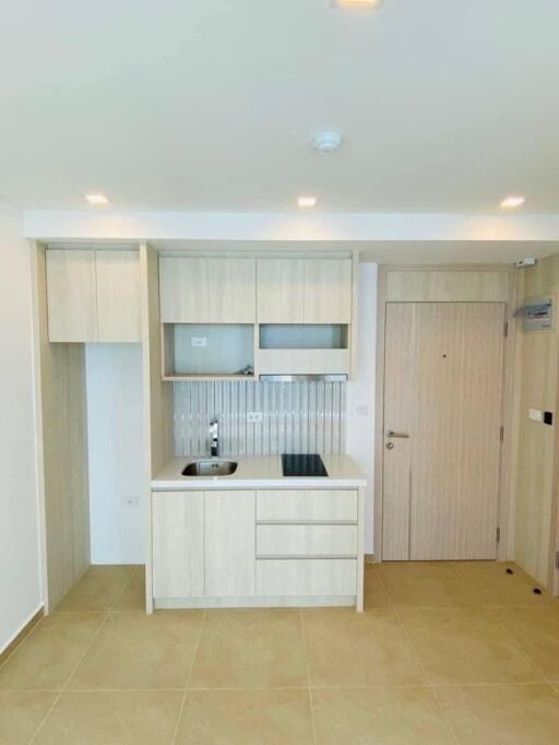 Modern minimalist kitchen area with built-in cabinets and stovetop