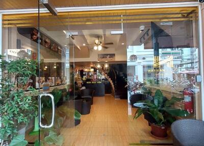 Welcoming lobby entrance with glass doors, plants, and seating area