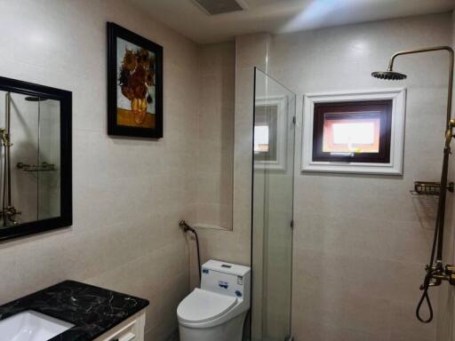 Modern bathroom with glass shower and black granite countertop