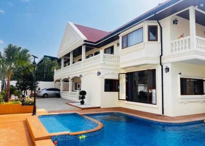 Exterior view of a large house with a pool