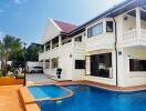 Exterior view of a large house with a pool