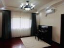 Living room with piano and overhead lighting