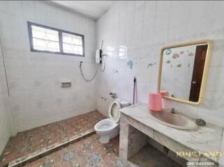 Simple bathroom with shower, toilet, and sink