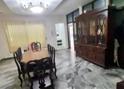 Dining room with marble floor and large wooden table