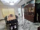 Dining room with marble floor and large wooden table