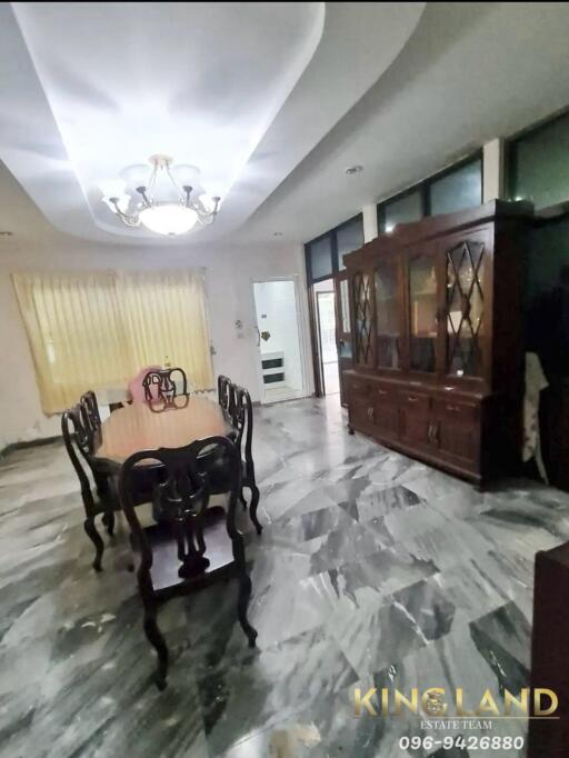 Dining room with marble floor and large wooden table