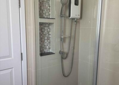 Modern bathroom shower area with glass door