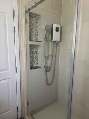 Modern bathroom shower area with glass door