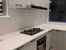 Modern kitchen with sleek white cabinetry and built-in appliances