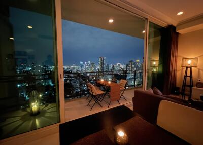 Modern living area with a view of the city skyline at night