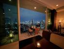 Modern living area with a view of the city skyline at night