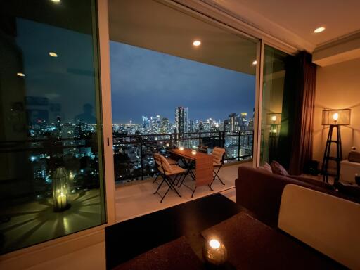 Modern living area with a view of the city skyline at night