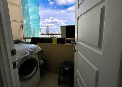 A view of a balcony with a washer and a scenic view outside