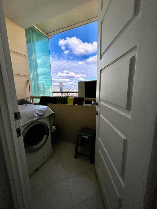 A view of a balcony with a washer and a scenic view outside