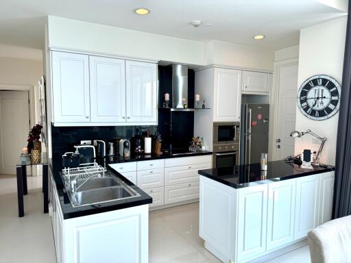 Modern kitchen with white cabinets and black countertops