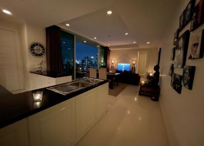 Modern open-plan living area with city view at night