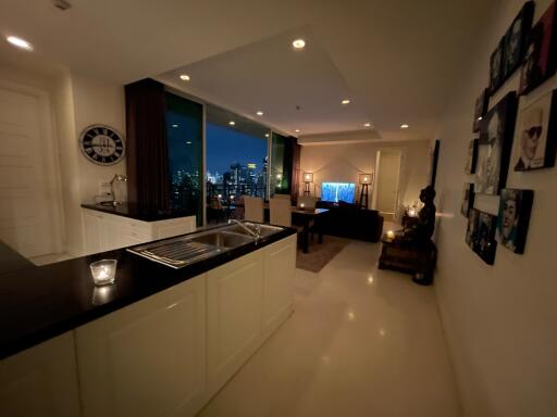 Modern open-plan living area with city view at night