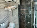 Modern bathroom with glass shower enclosure and grey tiles