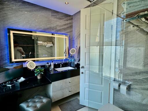 Modern bathroom with illuminated mirror and glass shower