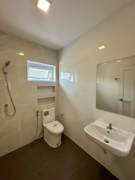 modern bathroom with shower, toilet, and sink