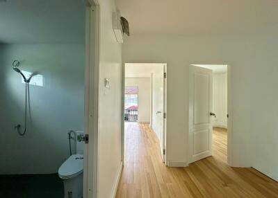 Bright, spacious hallway with access to a bathroom and two rooms