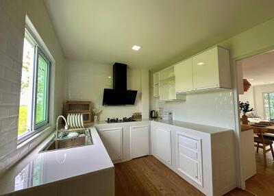 Modern kitchen with white cabinets and wooden flooring