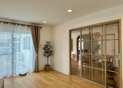 Modern living room with wooden floor and sliding glass doors