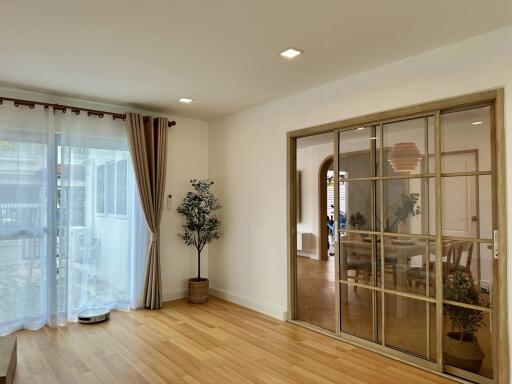 Modern living room with wooden floor and sliding glass doors