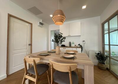 Dining area with a modern setup, featuring a wooden table and chairs