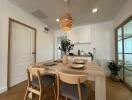 Dining area with a modern setup, featuring a wooden table and chairs