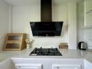 Modern kitchen with black stove and hood