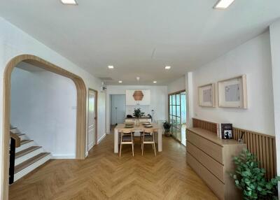 Modern dining area with wooden accents and herringbone flooring