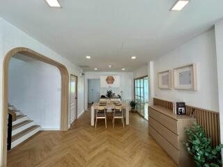 Modern dining area with wooden accents and herringbone flooring