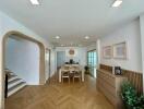 Modern dining area with wooden accents and herringbone flooring