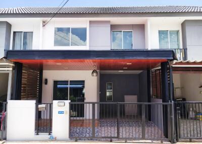 Modern townhouse exterior with gated entrance