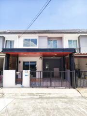 Modern townhouse exterior with gated entrance