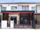 Modern townhouse exterior with gated entrance