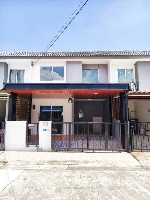 Modern townhouse exterior with gated entrance