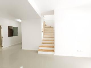 Modern white staircase in a bright home